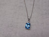 14KTWG Blue Topaz Necklace: Emerald Cut Diamond Accent