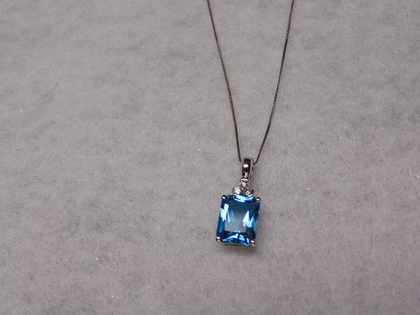 14KTWG Blue Topaz Necklace: Emerald Cut Diamond Accent