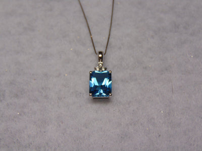14KTWG Blue Topaz Necklace: Emerald Cut Diamond Accent