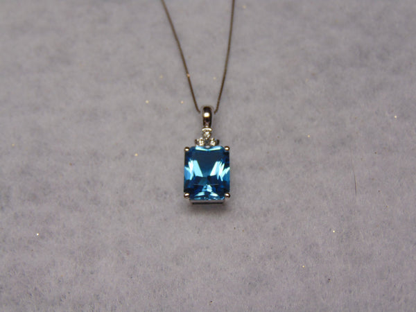 14KTWG Blue Topaz Necklace: Emerald Cut Diamond Accent