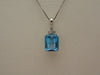 14KTWG Blue Topaz Necklace: Emerald Cut Diamond Accent