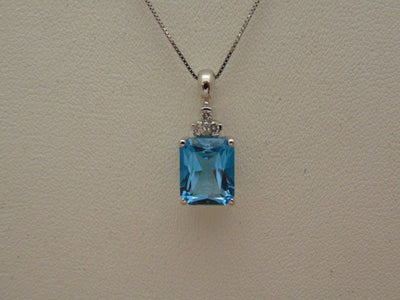14KTWG Blue Topaz Necklace: Emerald Cut Diamond Accent