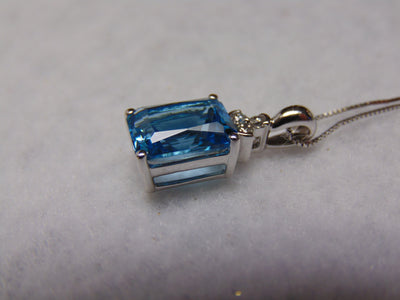 14KTWG Blue Topaz Necklace: Emerald Cut Diamond Accent