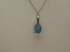 14KTWG Blue Topaz Necklace: Emerald Cut Diamond Accent