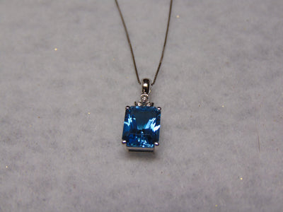 14KTWG Blue Topaz Necklace: Emerald Cut Diamond Accent