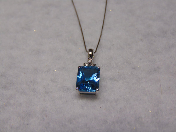 14KTWG Blue Topaz Necklace: Emerald Cut Diamond Accent