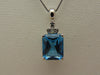14KTWG Blue Topaz Necklace: Emerald Cut Diamond Accent